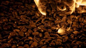 Coffee beans are roasted with tongues of bright flame. Macro background. Filmed is slow motion 1000 fps. video