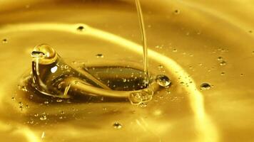 Olive oil pours in a stream with splashes. Macro background. Filmed on a high-speed camera at 1000 fps. video