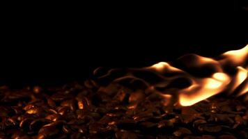 Coffee beans burn with flames. On a black background. Filmed is slow motion 1000 fps. High quality FullHD footage video