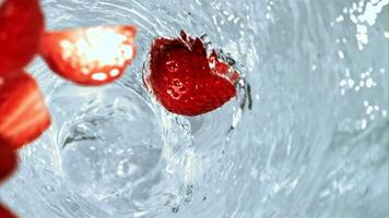 Strawberries fall into a whirlpool. Filmed is slow motion 1000 fps. High quality FullHD footage video