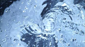 A whirlpool of water with air bubbles. Top view. Macro background.Filmed is slow motion 1000 fps. video