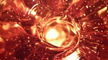 Whirlpool of whiskey. Macro background. Whiskey texture. Filmed on a high-speed camera at 1000 fps. High quality FullHD footage video