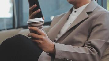 Smiling businesswoman using phone in office. Small business entrepreneur looking at her mobile phone and smiling. video