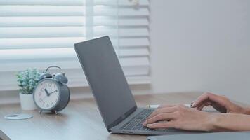 avvicinamento Immagine di un' attività commerciale donna di mani Lavorando e digitando su il computer portatile tastiera su bicchiere tavolo video