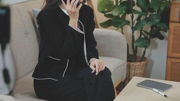 Smiling businesswoman using phone in office. Small business entrepreneur looking at her mobile phone and smiling. video