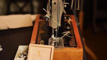 Tools on workstation in fashion atelier, needles and threads used for sewing and manufacturing clothes. Tailor workshop filled with textile industry equipment, craftsmanship. Close up. photo