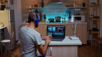 Creative filmmaker editing video footage in home using modern technology. Man content creator in home working on montage of film in new software for editing late at night. photo