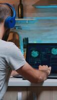 Male hacker failing in coding a dangerous virus to attack company database, angrily shutting down the laptop. Programmer writing a malware for cyber attacks using performance device during midnight. photo