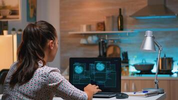 Hacker woman finishing succesfully hacking company system stealing database company. Programmer writing a dangerous malware for cyber attacks using performance laptop during midnight. photo
