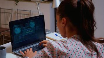 International hacker wanted for cyber crimes against the government working from home on professional device. Programmer writing a dangerous malware attacks using performance device during midnight. photo