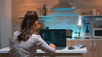 Woman remote thief stealing data from company hacking system from home. Programmer writing a dangerous malware for cyber attacks using performance laptop during midnight. photo