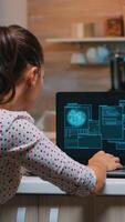 Woman hacker coding html and programming on screen laptop working from home in midnight. Programmer writing a dangerous malware for cyber attacks using performance device during midnight. photo