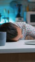 Businesswoman who worked until midnight on project felling asleep on desk working from home with hand on keyboard. Employee using modern technology network wireless doing overtime sleeping on table. photo