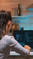Woman remote thief stealing data from company hacking system from home. Programmer writing a dangerous malware for cyber attacks using performance laptop during midnight. photo