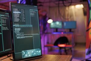 Multiple windows with internet virus software and ransomware running code on computer screens. Server breaking and data breaching malware on monitors in hacker hideout workspace at night time photo