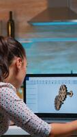 Young remote woman architect working on modern cad program overtime. Industrial female engineer studying prototype idea on personal computer showing cad software on device display photo