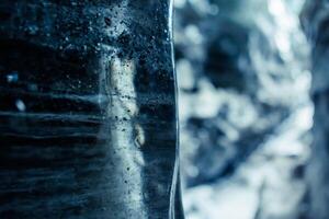 Icelandic glacier ice blocks in crevasse, frozen wintry landscapes with transparent rocks inside ice caves. Water dripping from cracked texture caverns of ice in iceland, vatnajokull. photo