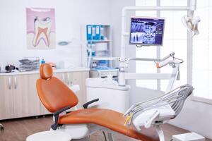 Radiography of patient jaw on screen display in dentist office. Stomatology equipment in dental private hospital with nobody in it. Different dental instruments and tools. photo