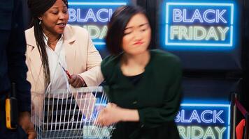 Aggressive clients start fight in store, black friday madness. People obsessed with shopping during seasonal sales event acting crazy after entering shopping center, crowd control. photo