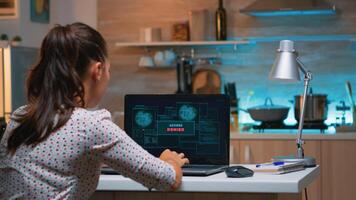 Nervous programmer hacker failing hacking company system from home at midnight. Professional woman writing a dangerous malware for cyber attacks using performance laptop late at night. photo