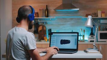 Remote man architect working from home at laptop on modern cad program overtime wearing headset. Industrial employee studying prototype idea on computer showing cad software on device display photo