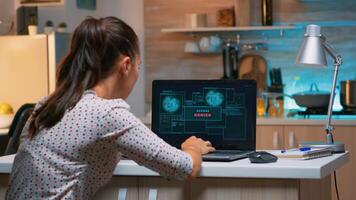 Angry female hacker of failing closing laptop working from home at computer. Programmer writing a dangerous malware for cyber attacks using performance pc during midnight. photo