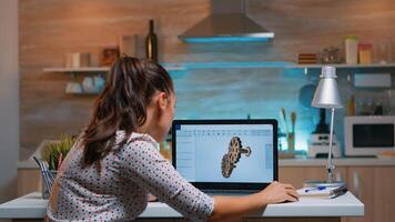 Young remote woman architect working on modern cad program overtime. Industrial female engineer studying prototype idea on personal computer showing cad software on device display photo