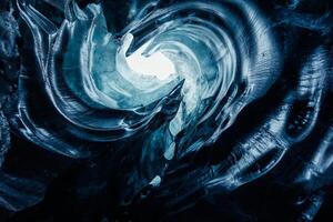 Beautiful iceberg crevasse in iceland forming massive icy tunnels with frosty structure, vatnajokull icelandic nature. Transparent ice glacier rocks inside cave, frozen stone pathways. photo