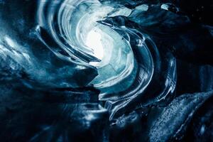 Gorgeous glacial crevasse in Iceland, Vatnajokull icelandic environment producing huge icy caverns with frozen composition. Inside the cave, clear glacial rocks and iced block routes. photo