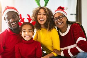 Happy African family having fun together celebrating Christmas holidays photo
