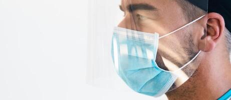 Doctor wearing ppe face surgical mask and visor fighting against corona virus outbreak - Health care and medical workers concept photo