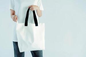 AI generated woman Hand holding a White Polyester square tote bag for mockup . AI generated image photo