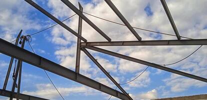 Structure of steel for building construction on sky background. photo