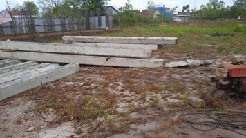 Stock of concrete piles at the construction site photo