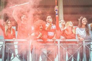 Football supporter fans watching international soccer match at stadium - Young group of excited friends having fun exulting at soccer world game - Youth, sport and celebration score concept photo