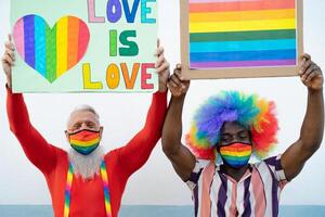 Activist people with different age and ethnicity protesting for gender equality - LGBT social movement concept photo