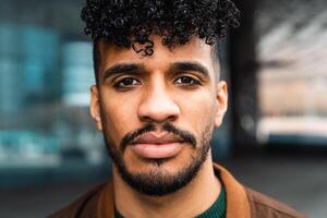 Young Latin man portrait looking in front of camera photo