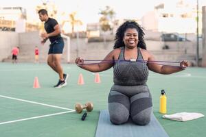 Curvy Afro woman doing workout  exercises session - Young African female having fun training outdoor - Sporty people lifestyle concept photo