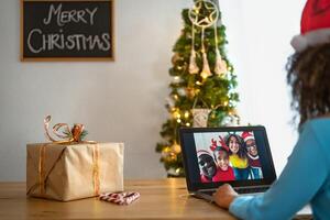 Happy African family having video call during Christmas time - Social distancing and technology concept photo