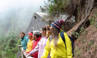 Group of women with different ages and ethnicities having fun walking in the woods - Adventure and travel people concept photo