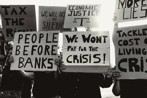 People protesting against financial crisis and global inflation - Economic justice activism concept - Black and white editing photo