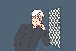 Man catholic priest listens to confession, located in church in room with mesh wall vector