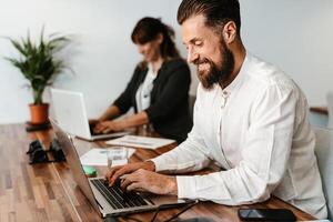 Multiracial people working inside coworking creative space photo