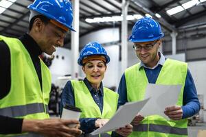 Team of multiracial engineers working in robotic factory - Tech industry concept photo