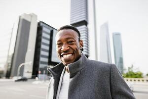 Happy African man in capital business city center photo