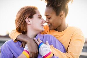 Happy women gay couple having tender moments during sunset outdoor - Lgbt and love relationship concept photo