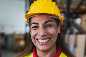 Portrait of happy Latin woman working in delivery warehouse - Logistic and industry concept photo