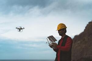 Male engineer doing inspection using drone - Technology and industrial concept photo