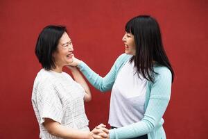 Happy Asian mother and daughter having tender moment together - Parents love concept photo