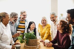 Happy multiracial friends with different ages and ethnicities having fun drinking coffee at home photo